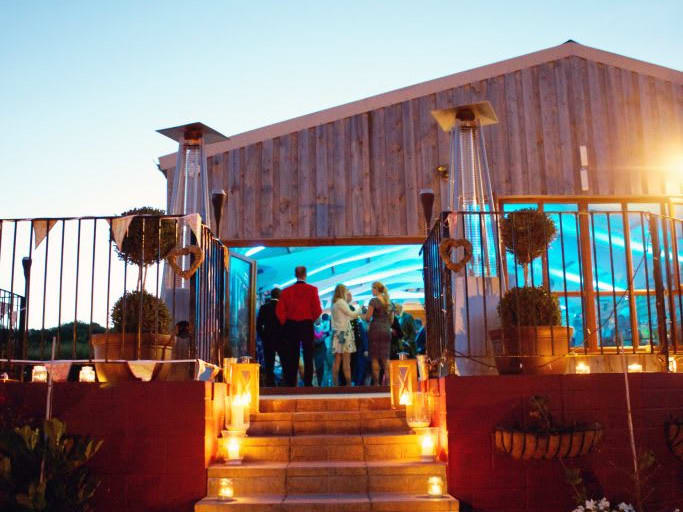 People at an event in a barn.