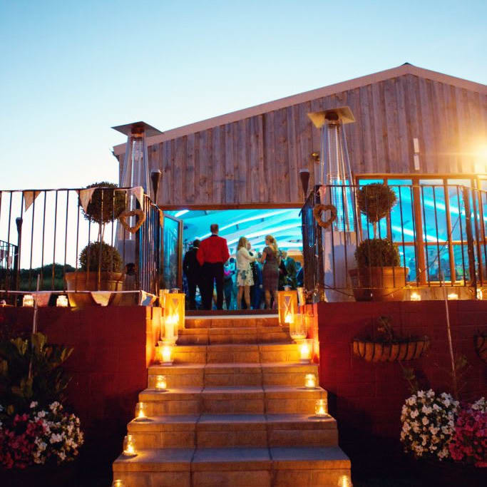 People at an event in a barn.