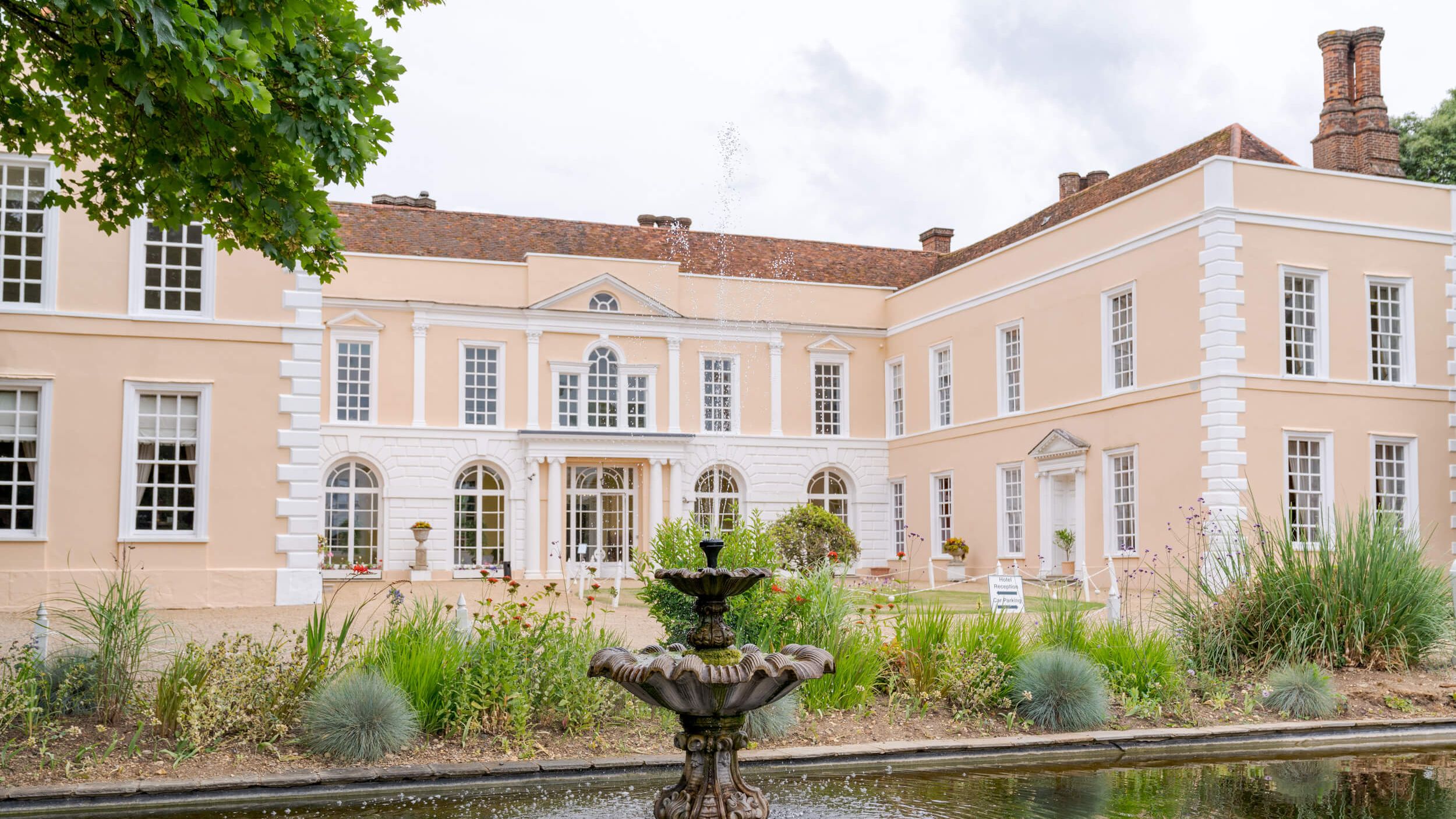 Large elegant manor house with a fountain in the front garden
