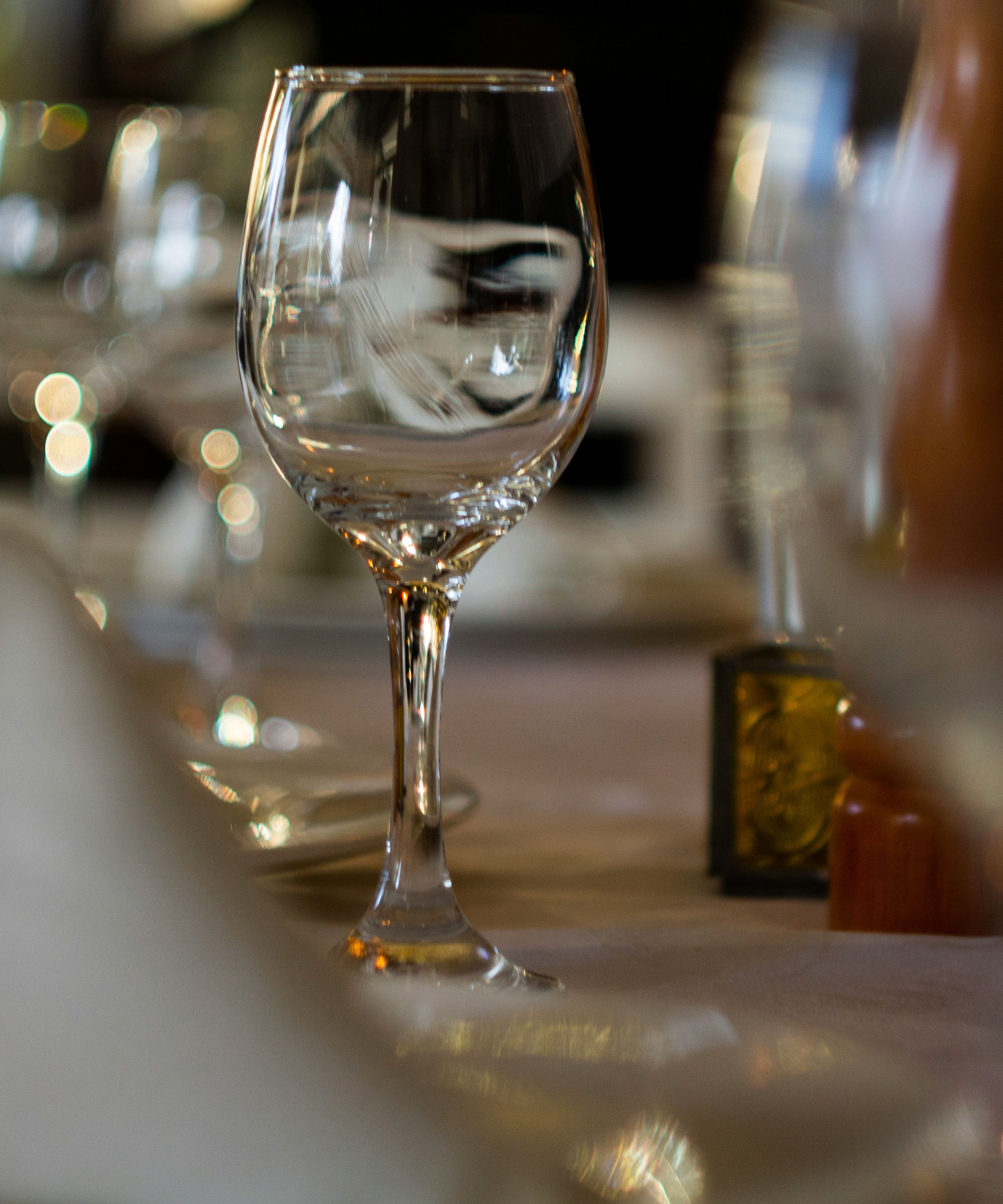 Close-up of an elegant restaurant table setting with empty wine glasses and folded napkins
