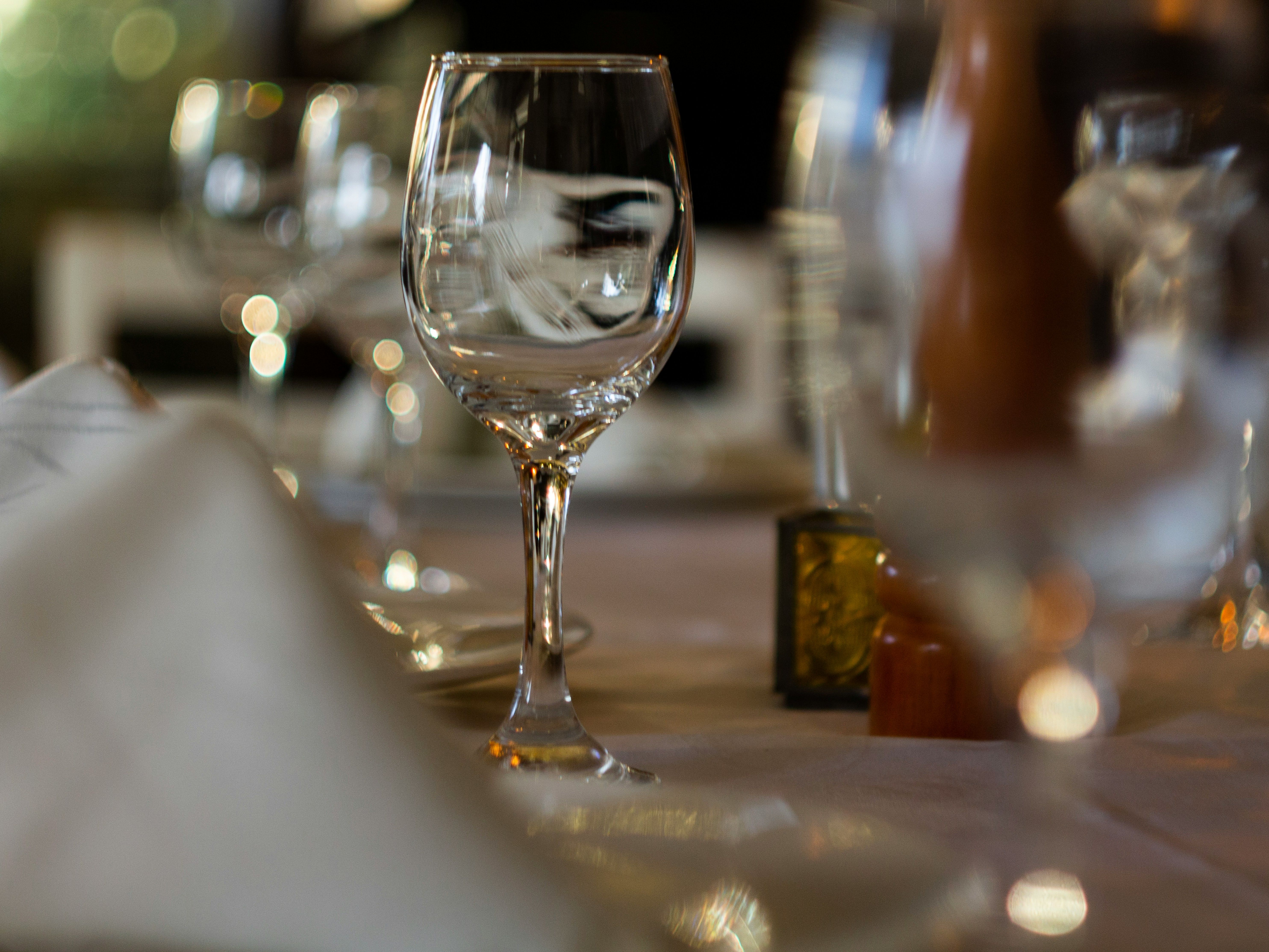 Close-up of an elegant restaurant table setting with empty wine glasses and folded napkins