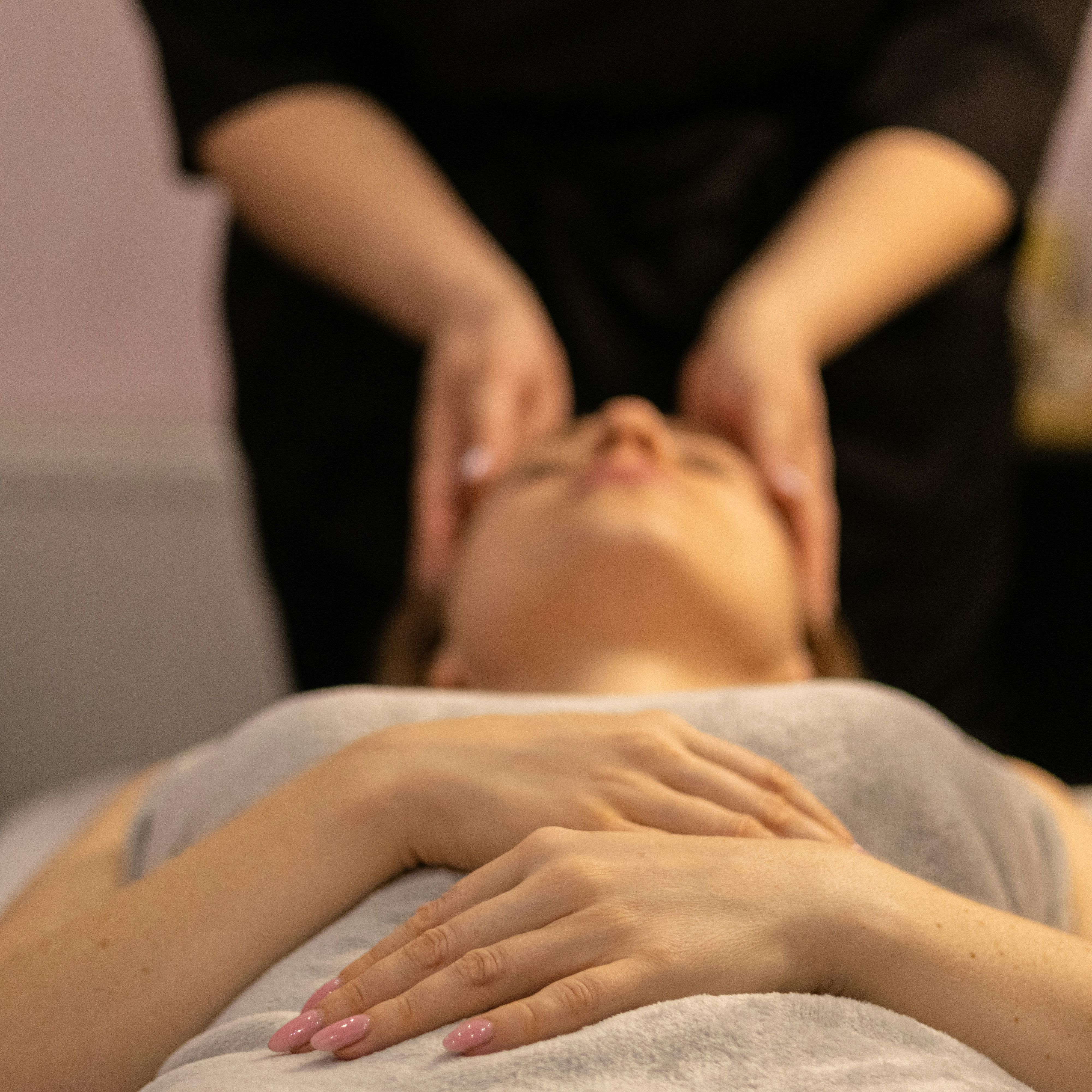 Person receiving a relaxing facial massage at a spa