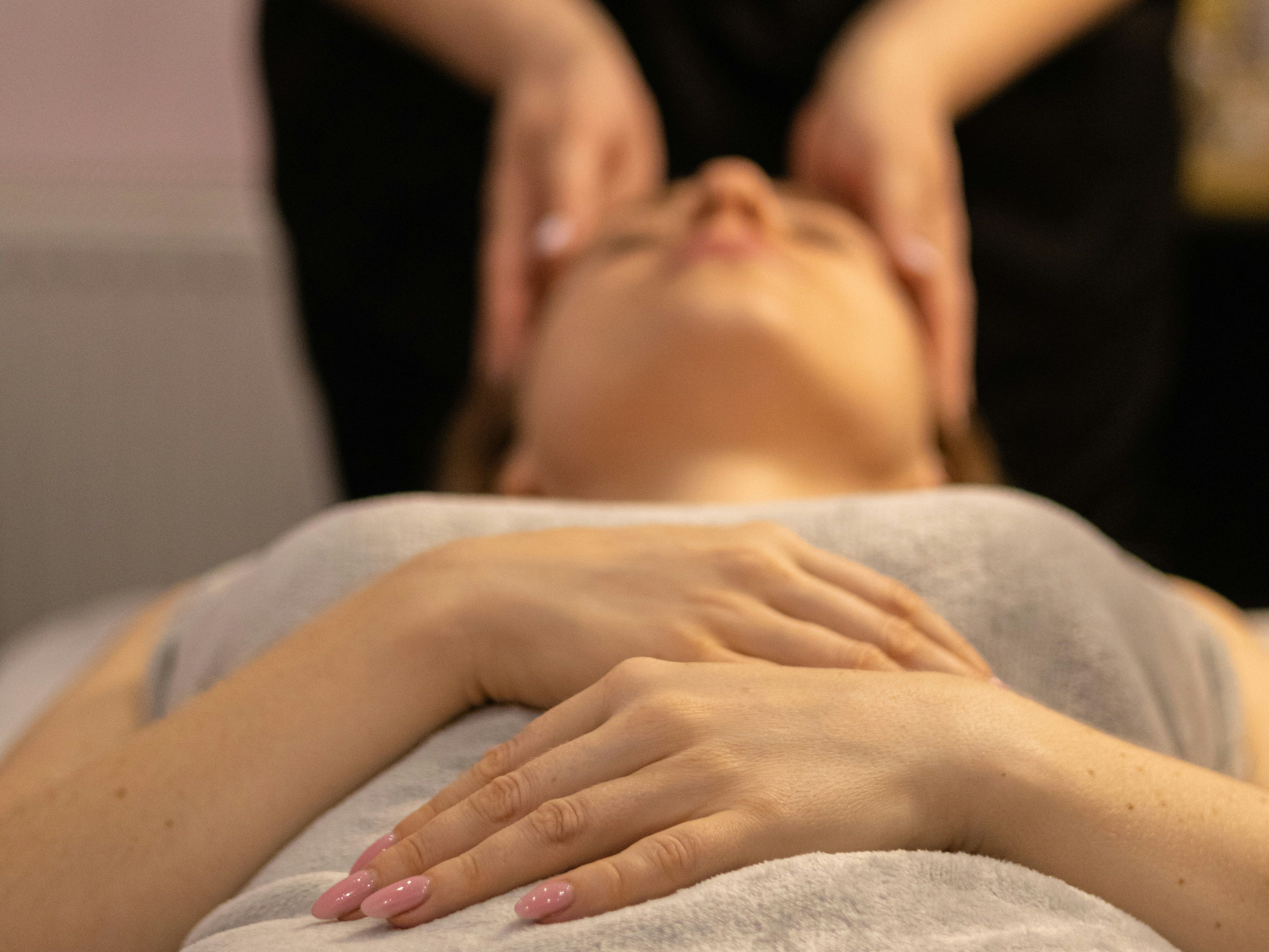 Person receiving a relaxing facial massage at a spa