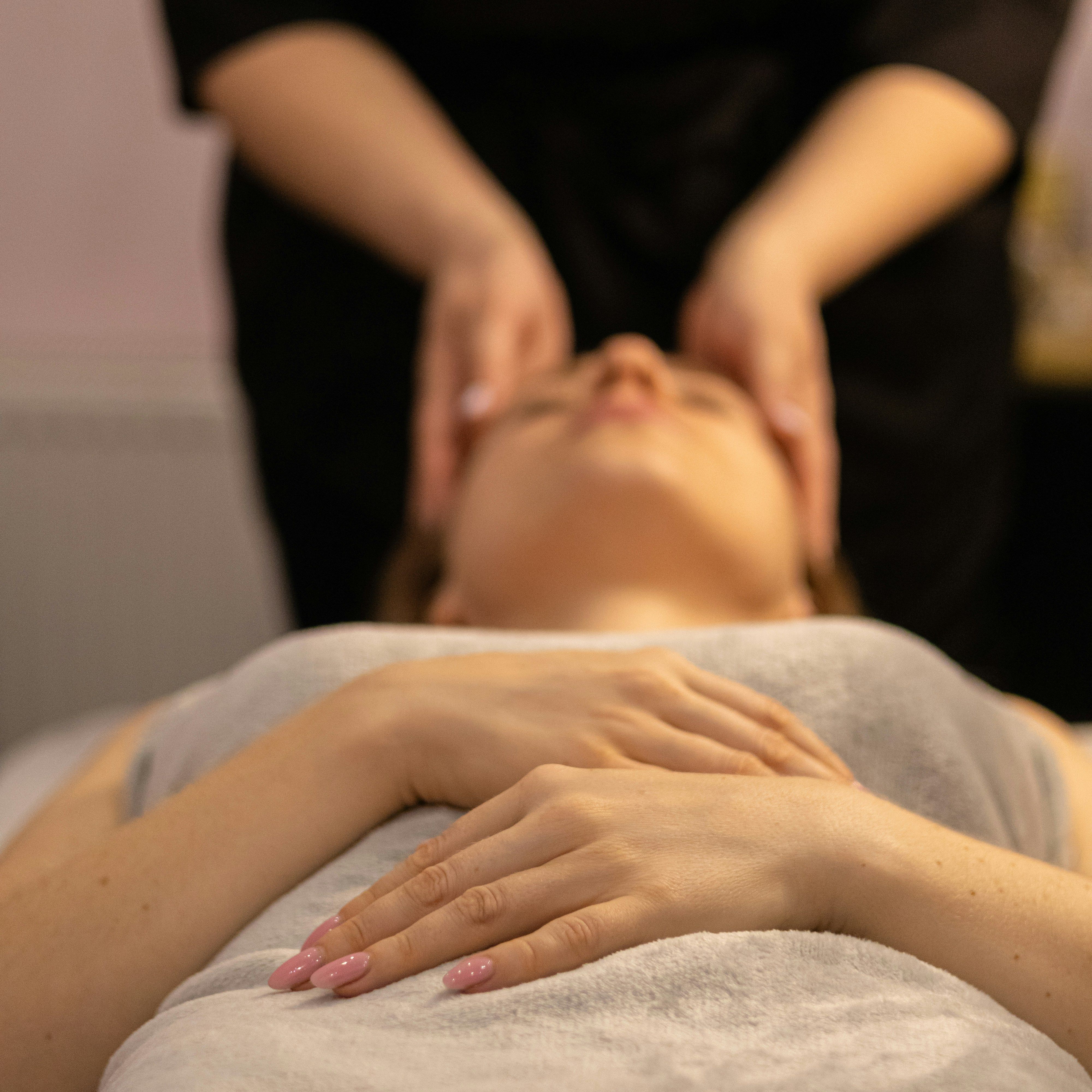 Person receiving a relaxing facial massage at a spa