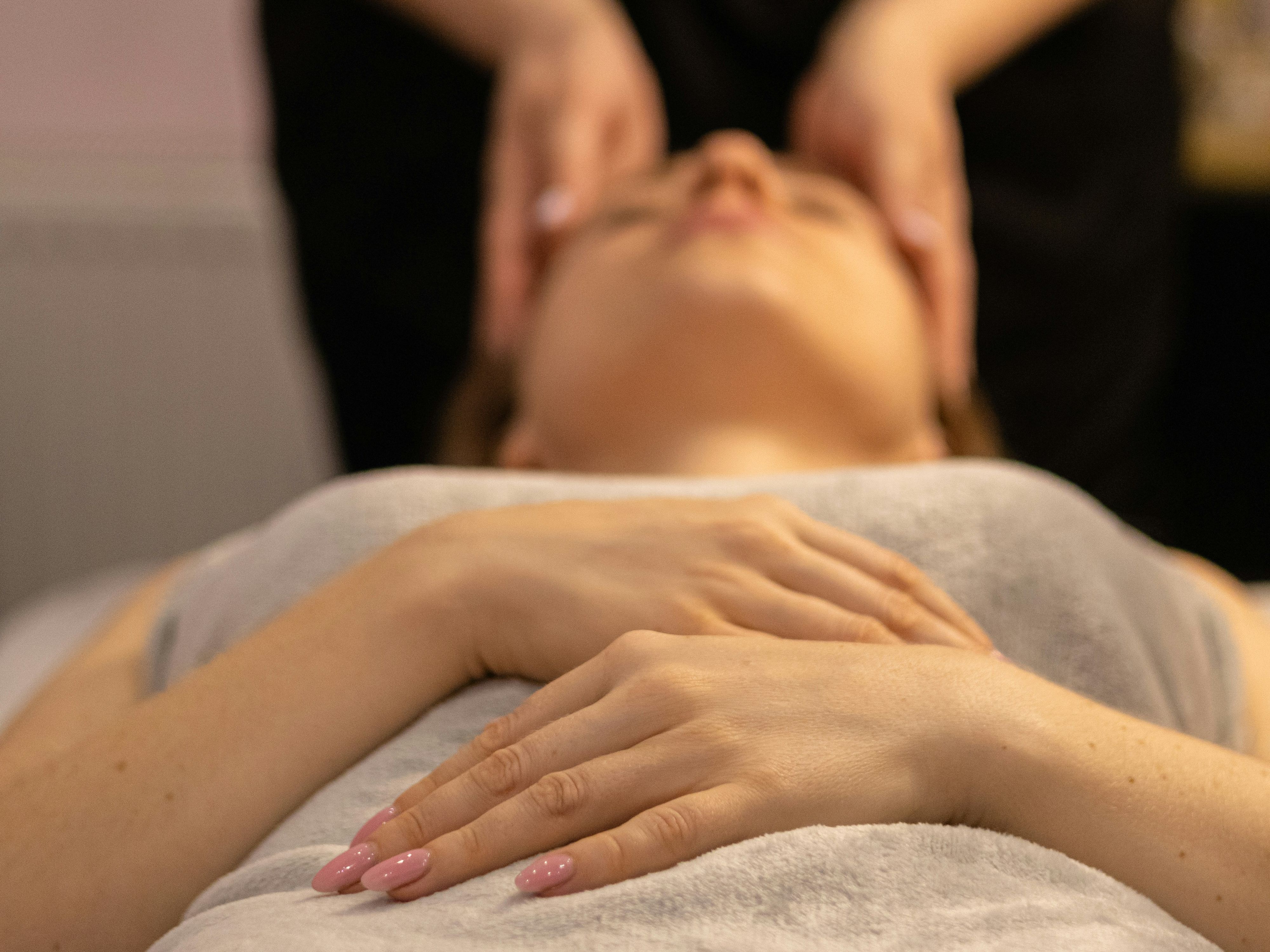 Person receiving a relaxing facial massage at a spa