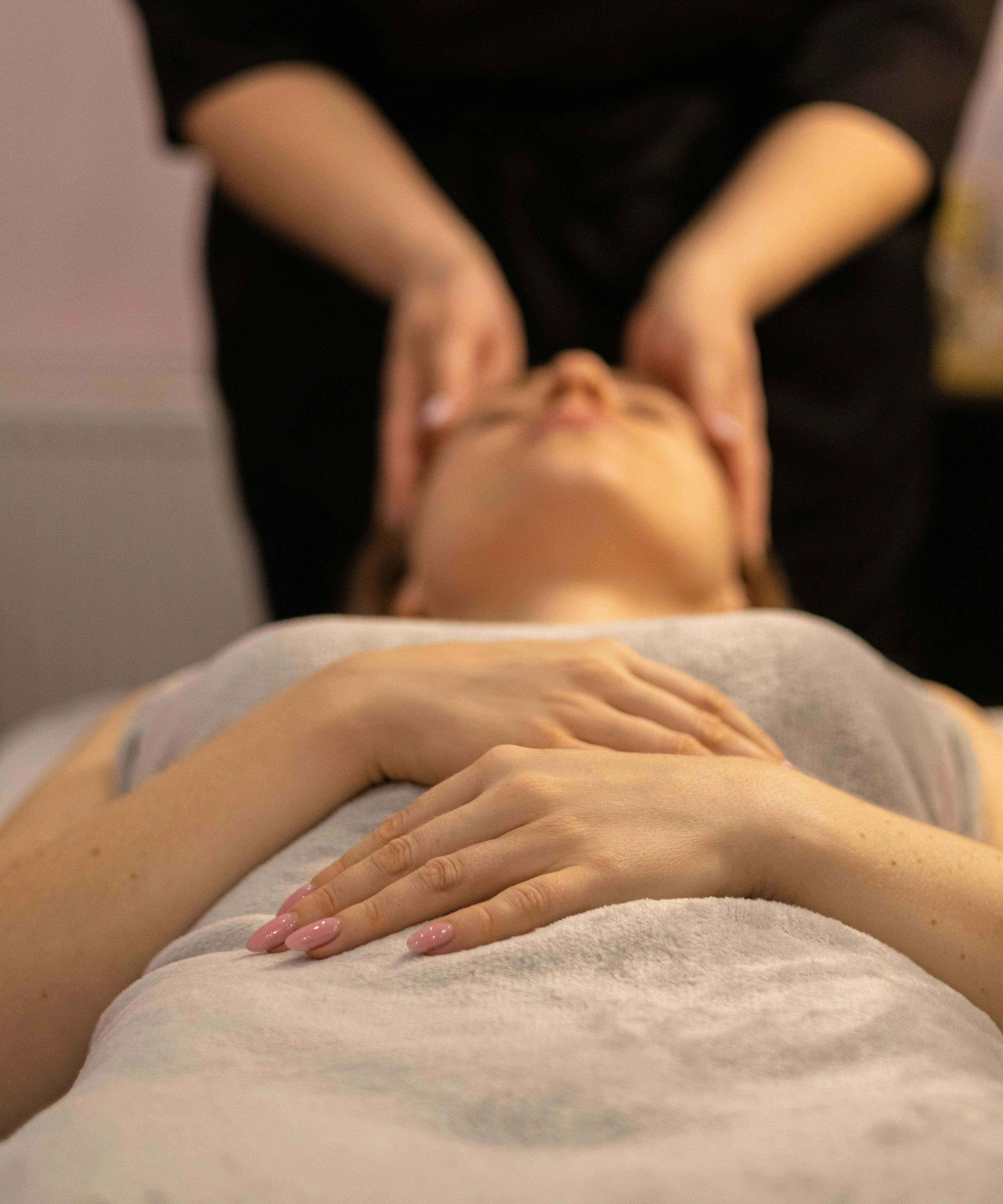 Person receiving a relaxing facial massage at a spa
