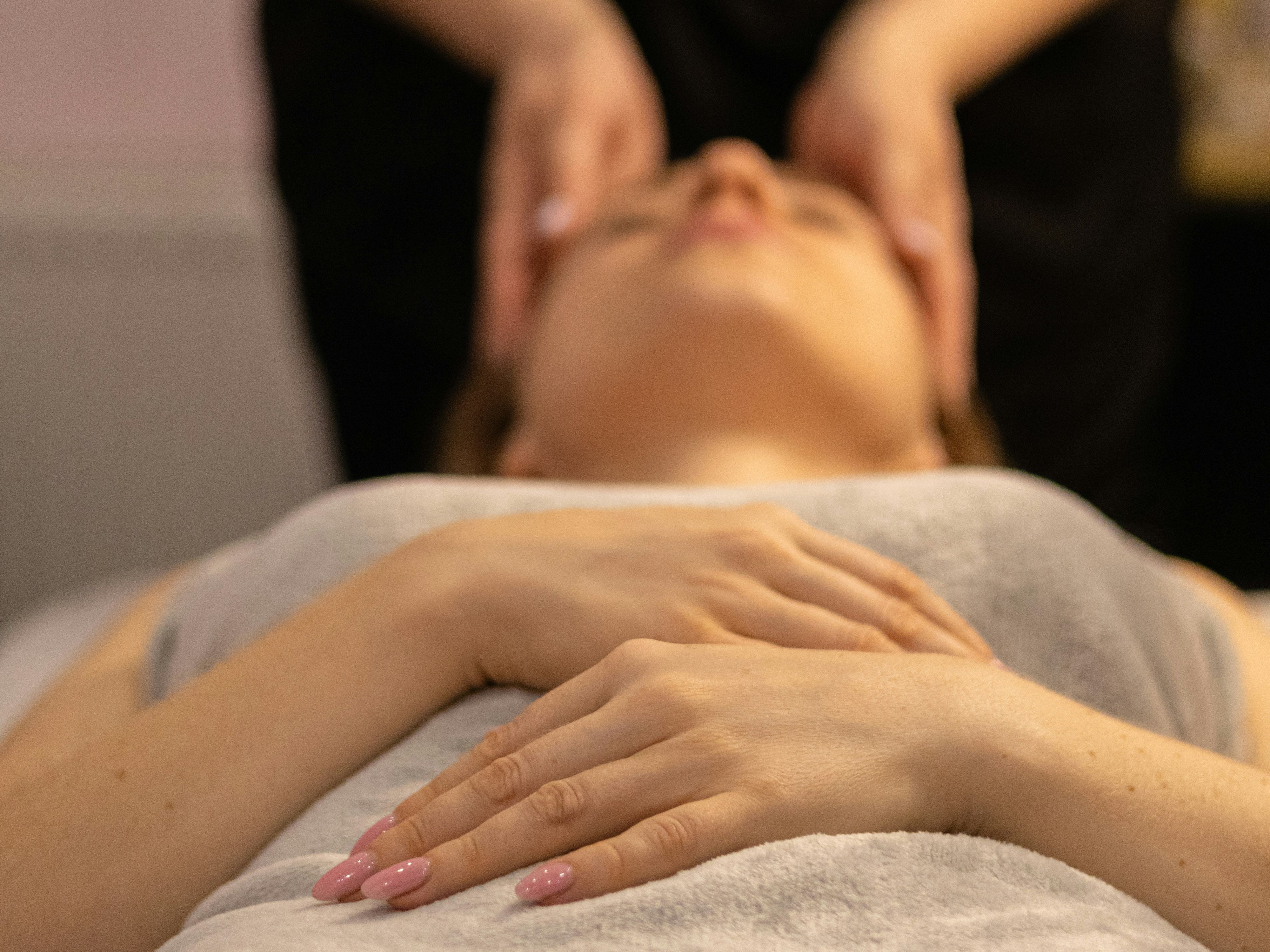 Person receiving a relaxing facial massage at a spa