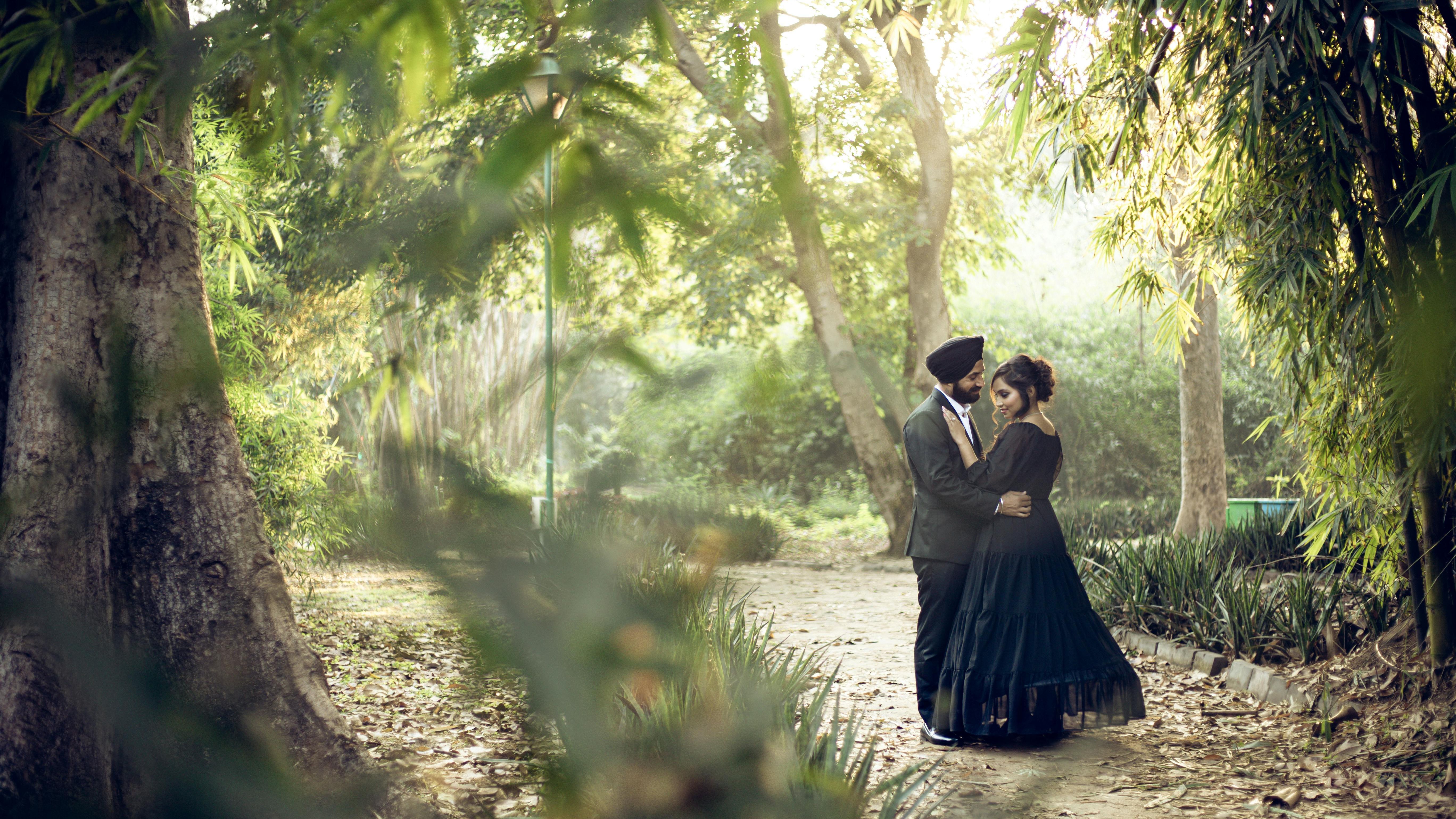Couple embracing in a sunlit forest setting