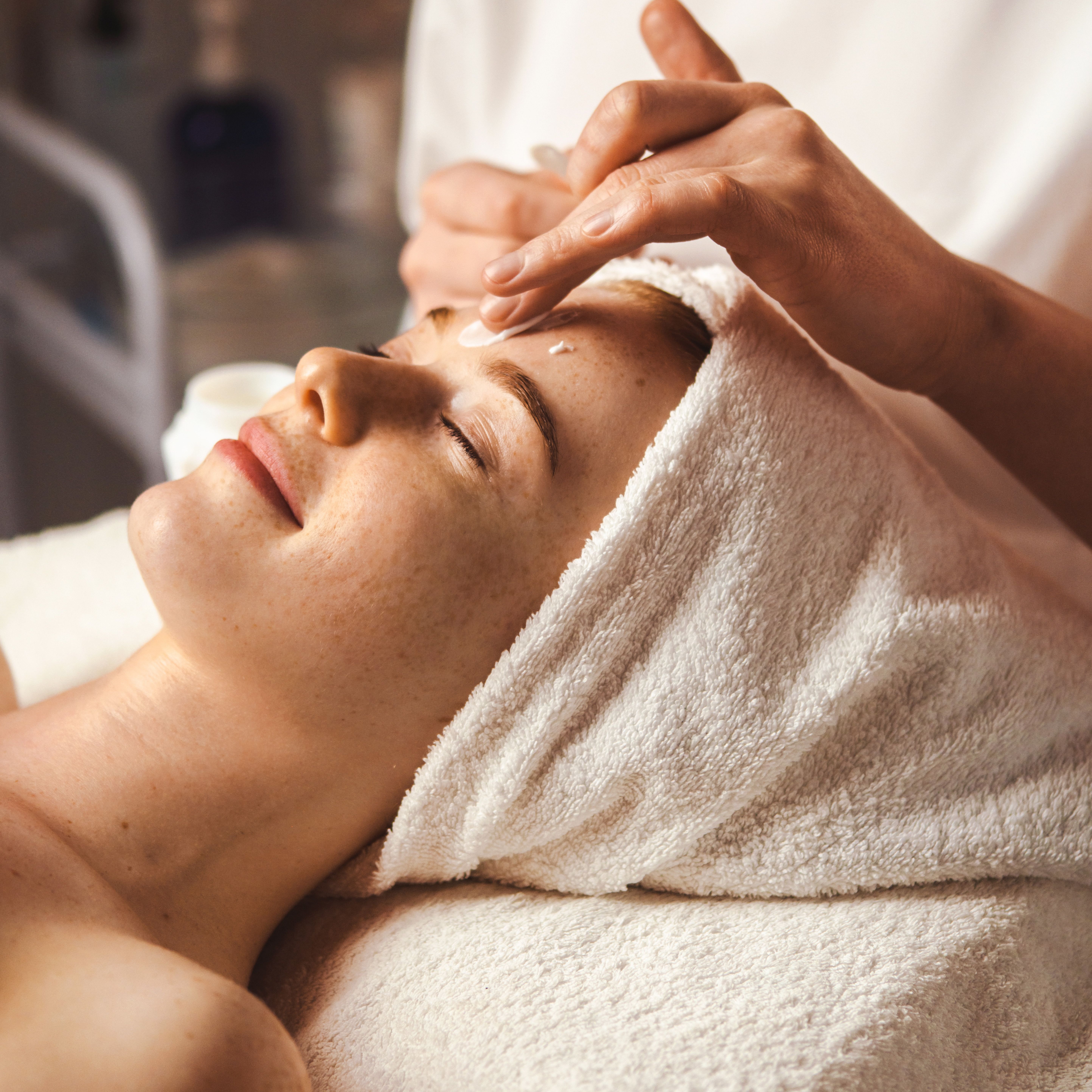 Woman receiving a facial treatment at a spa