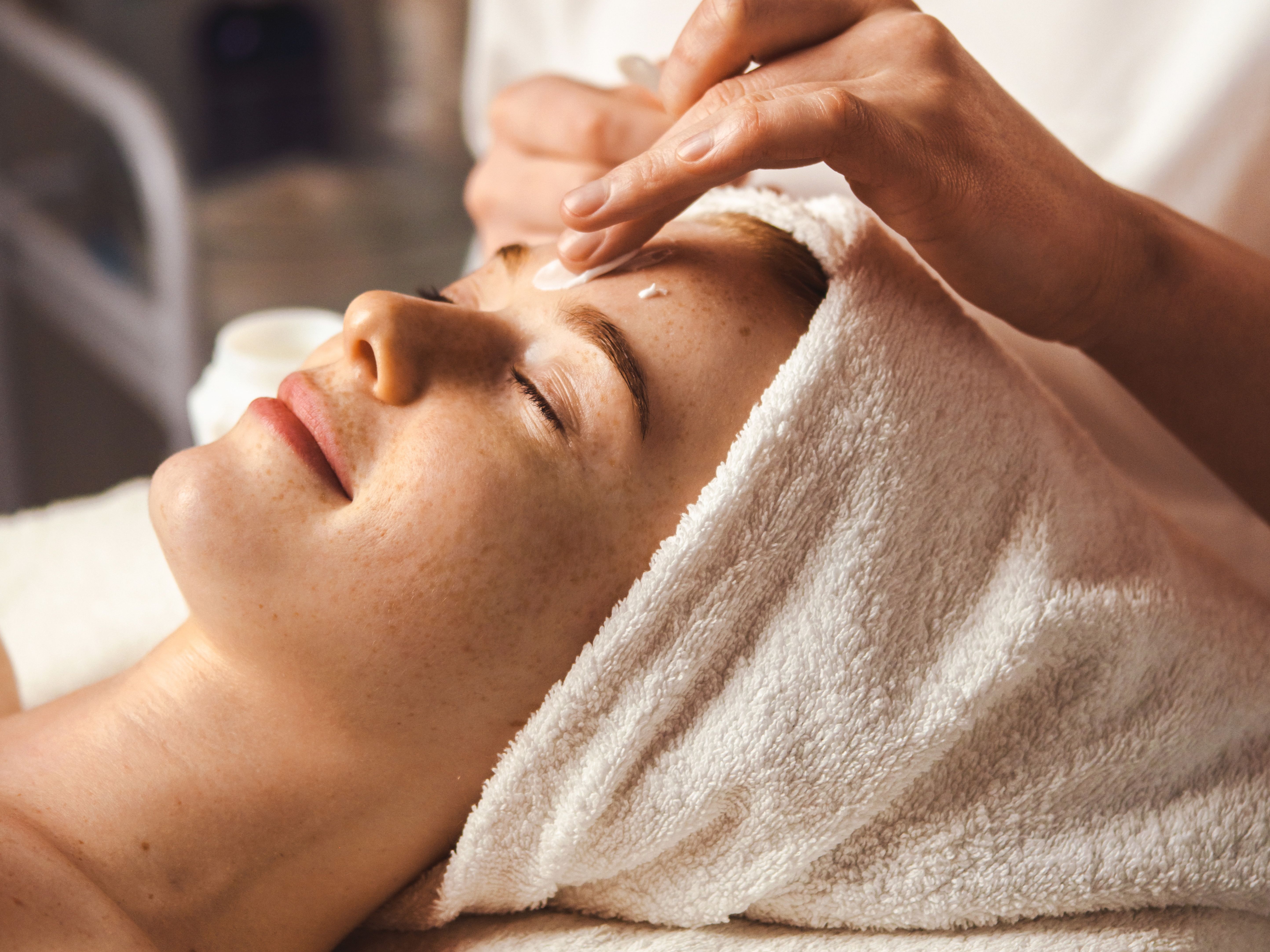 Woman receiving a facial treatment at a spa