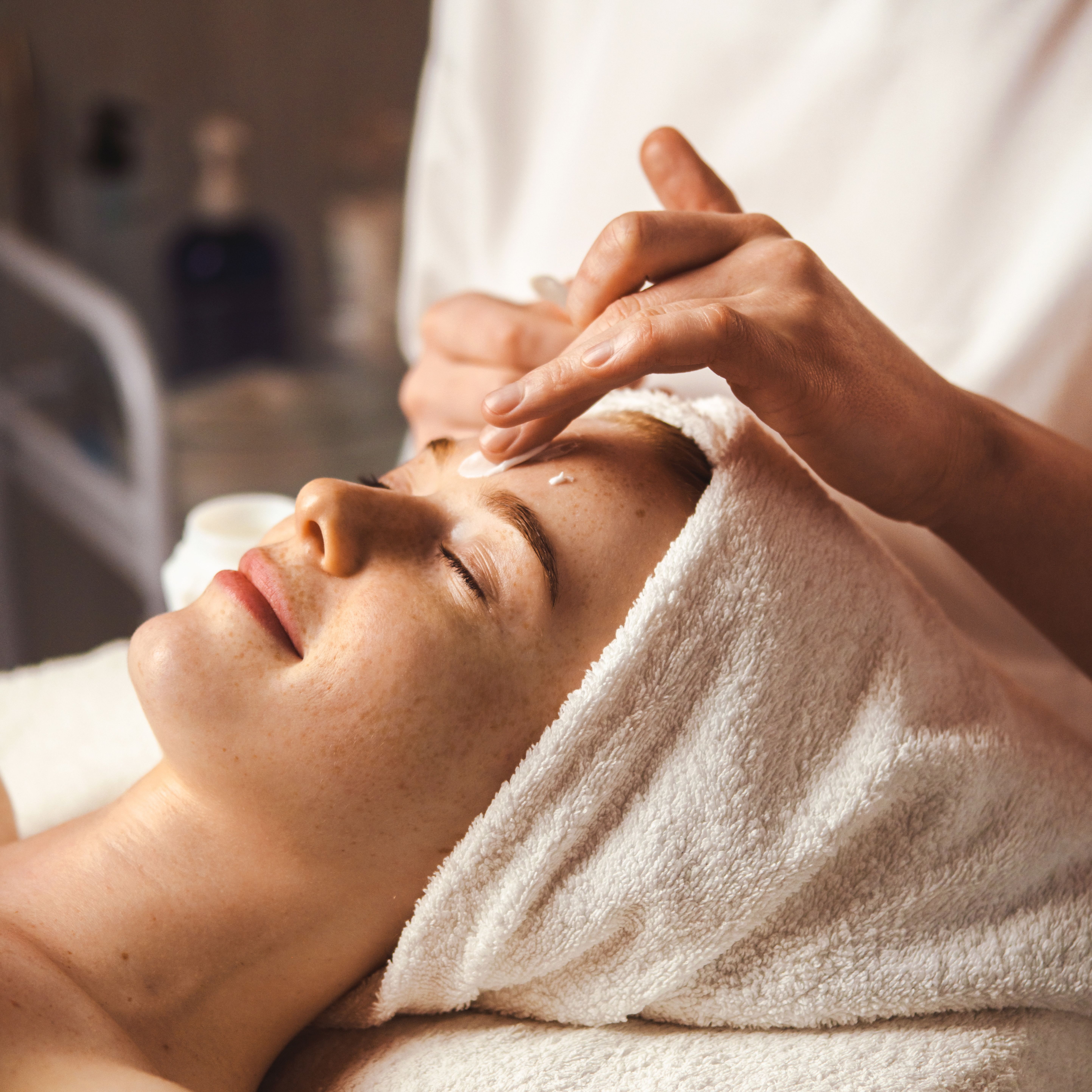 Woman receiving a facial treatment at a spa