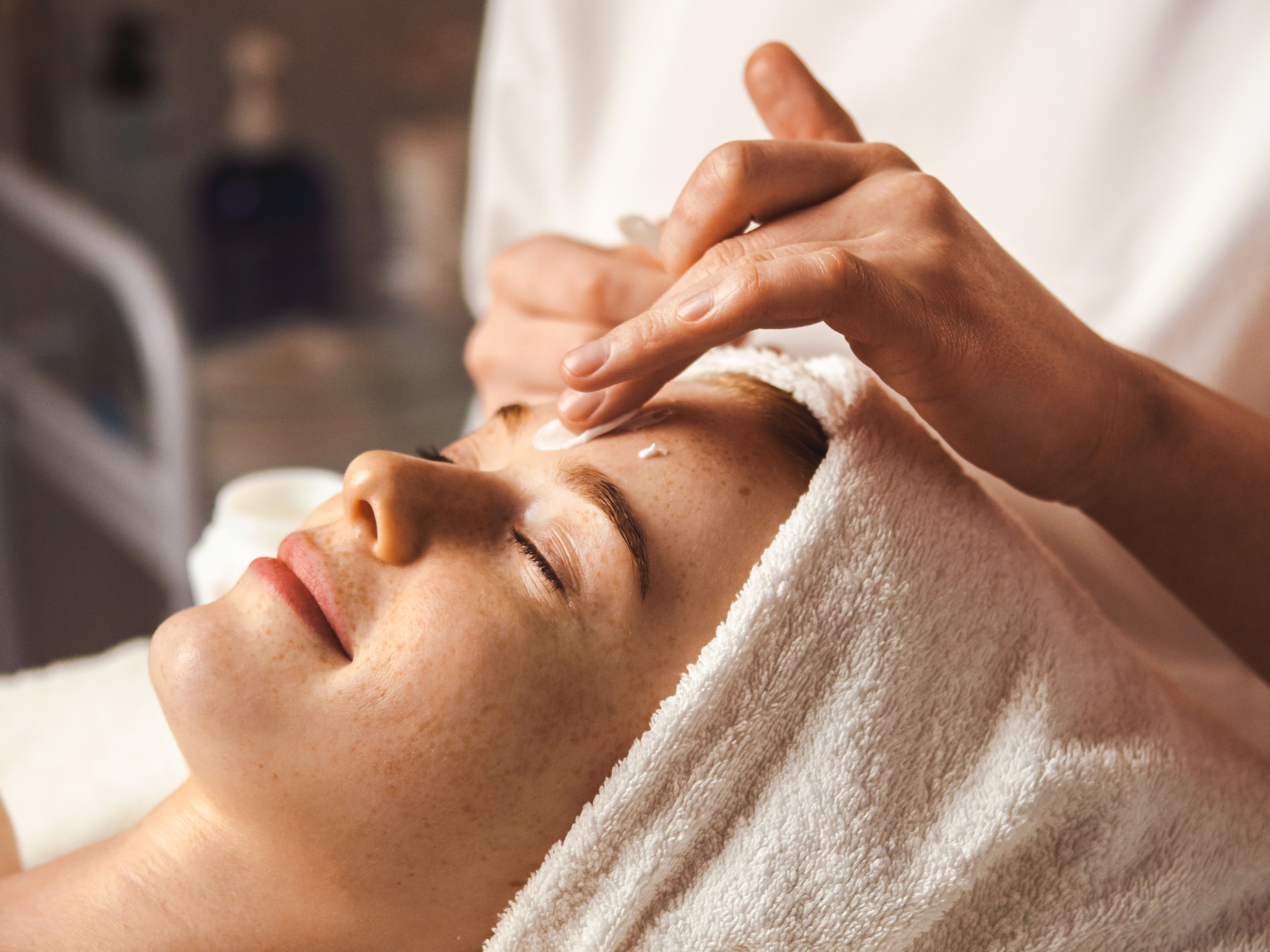 Woman receiving a facial treatment at a spa