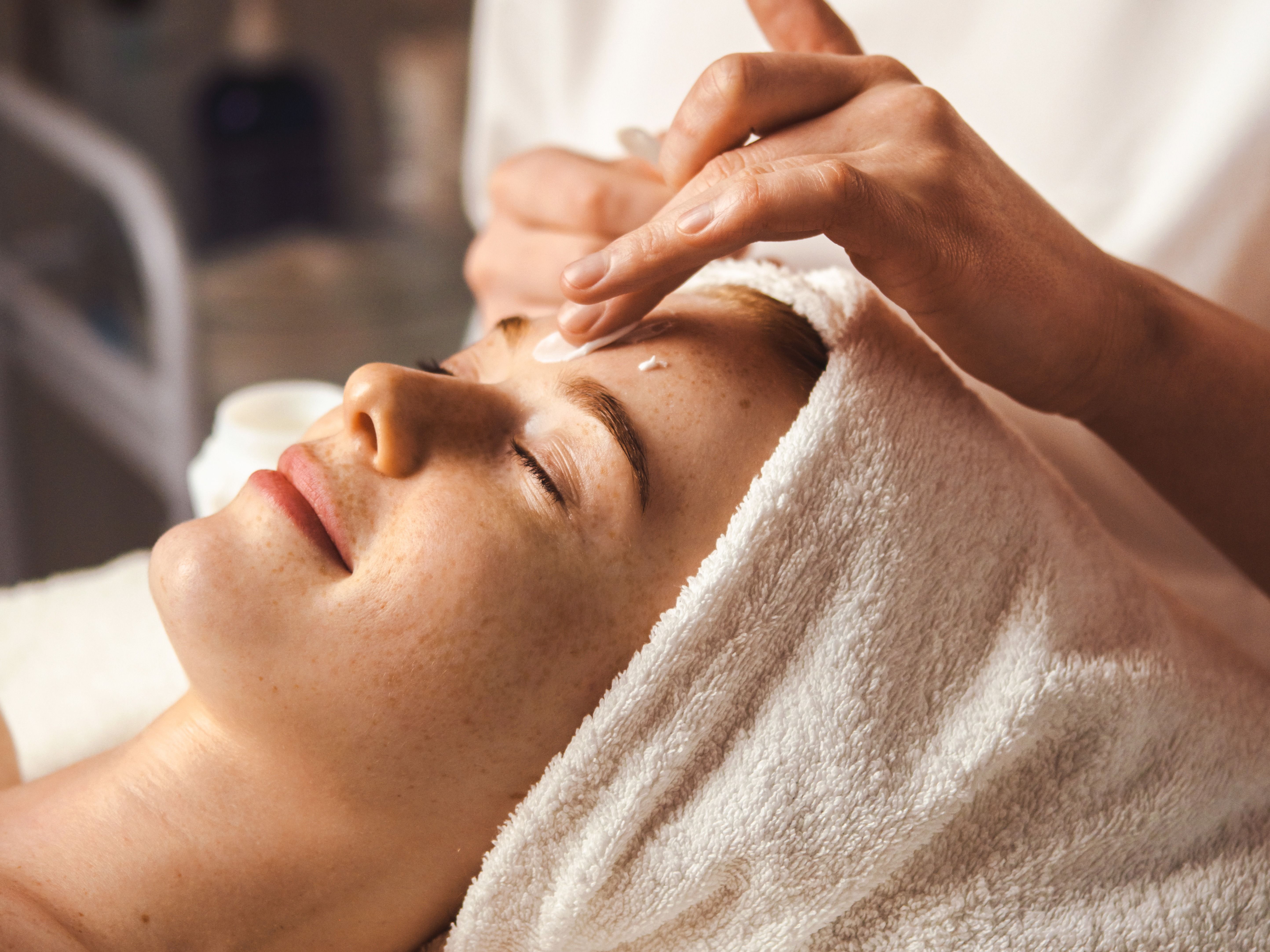 Woman receiving a facial treatment at a spa
