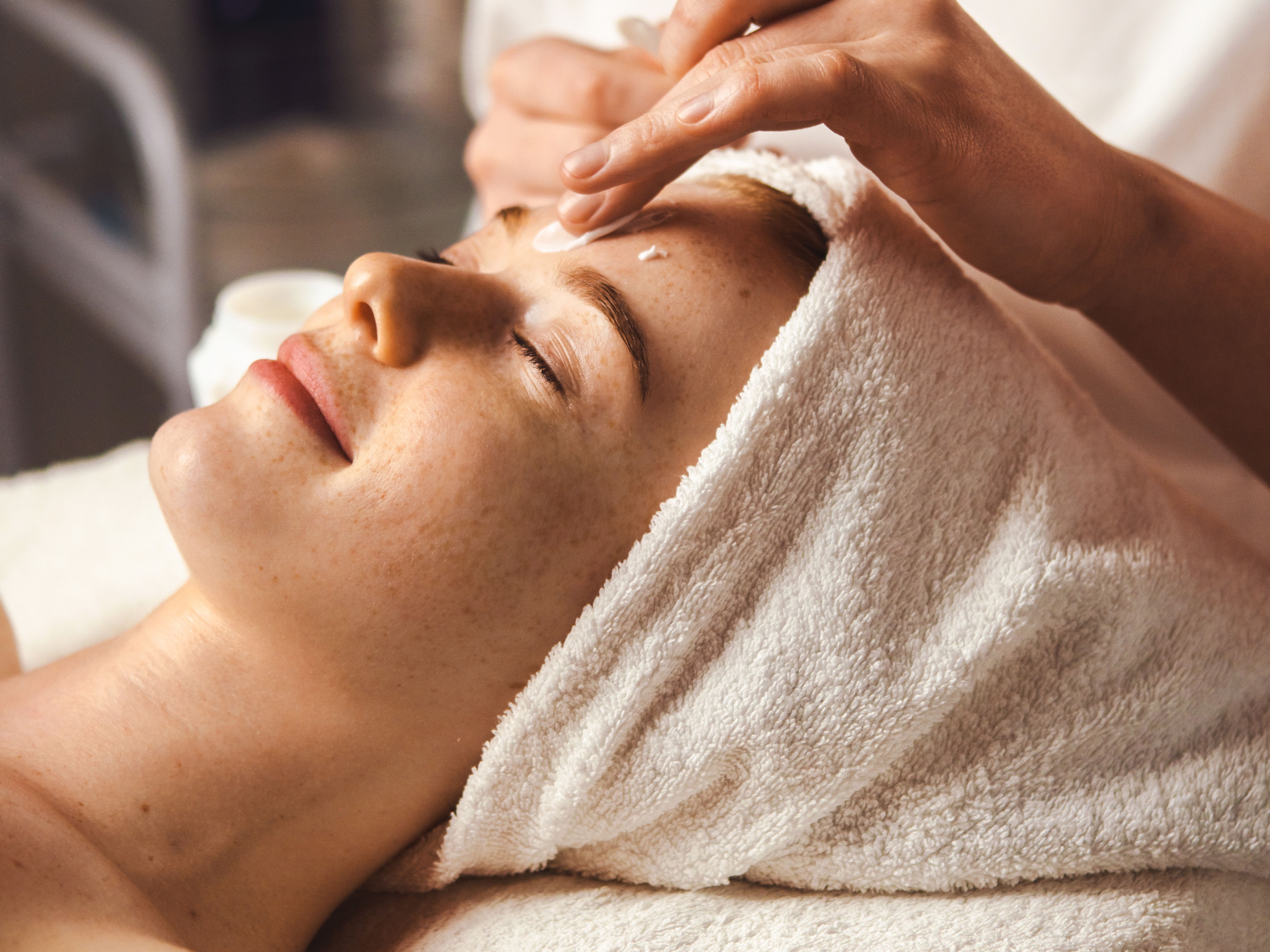 Woman receiving a facial treatment at a spa