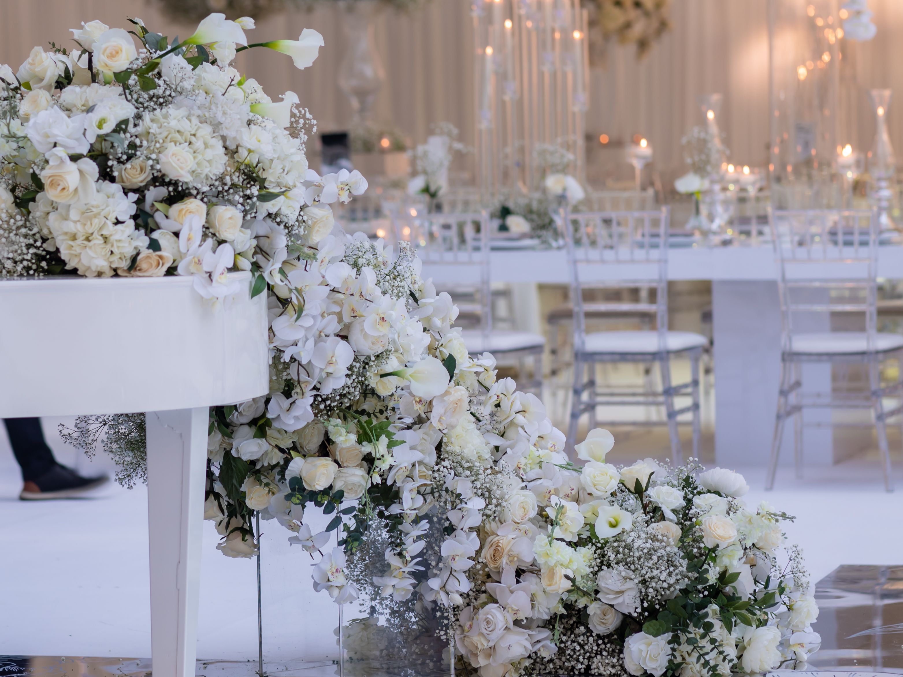Elegant wedding reception with white floral arrangements and candles