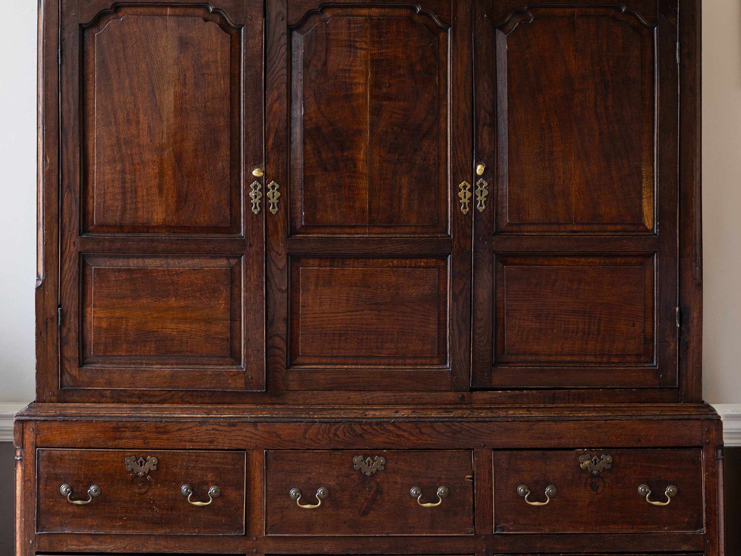 Antique wooden wardrobe with drawers and ornate handles