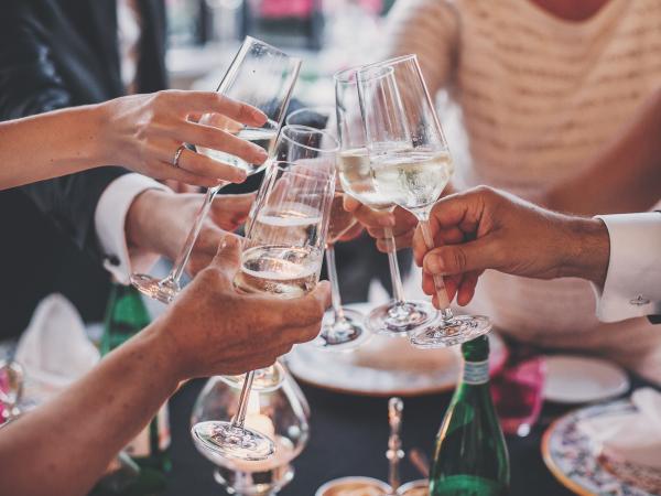 People making a toast with champagne glasses at a formal event
