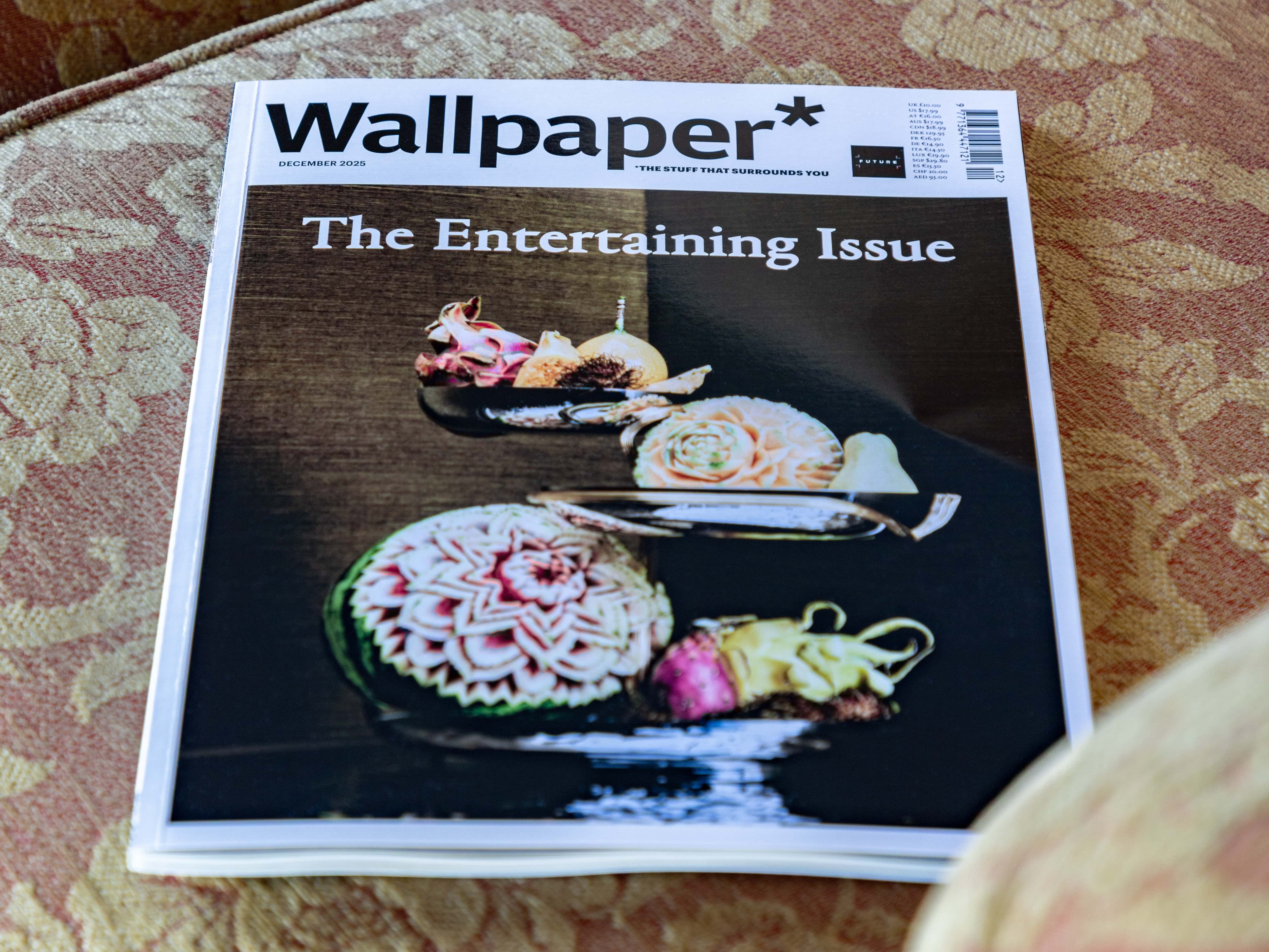 Wallpaper magazine titled 'The Entertaining Issue' placed on a patterned couch