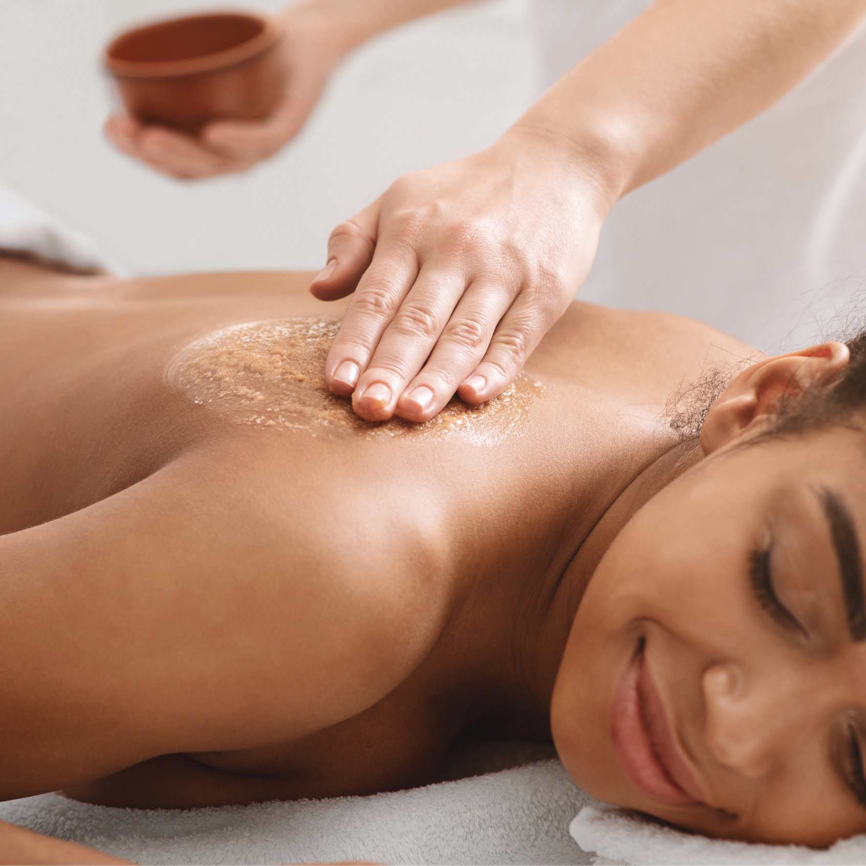 Woman receiving a relaxing back scrub massage at a spa