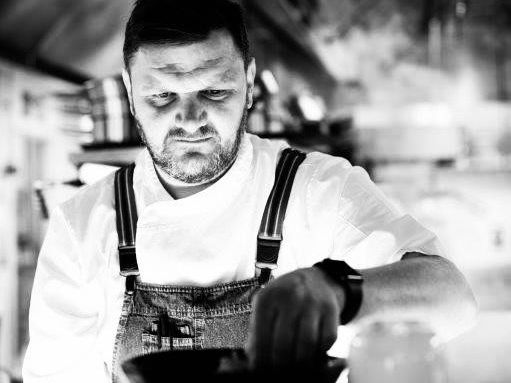 Chef preparing a dish in a professional kitchen