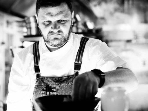 Chef preparing a dish in a professional kitchen
