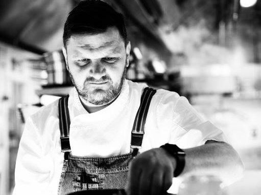 Chef preparing a dish in a professional kitchen