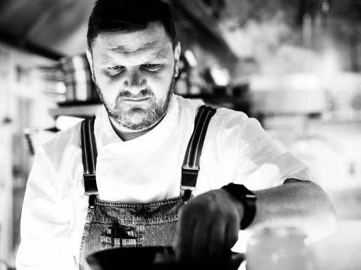 Chef preparing a dish in a professional kitchen