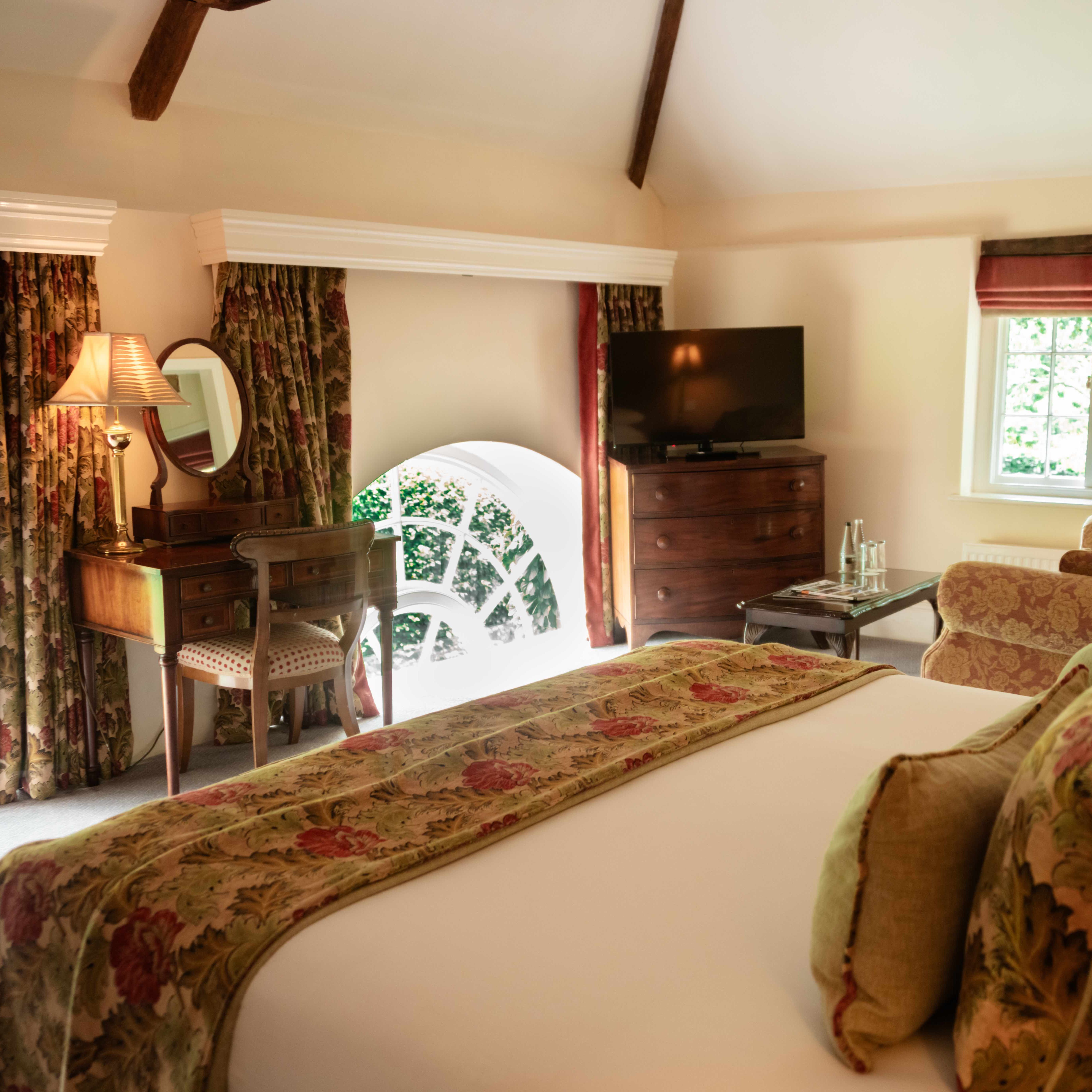 Cozy hotel room with floral decor and large windows