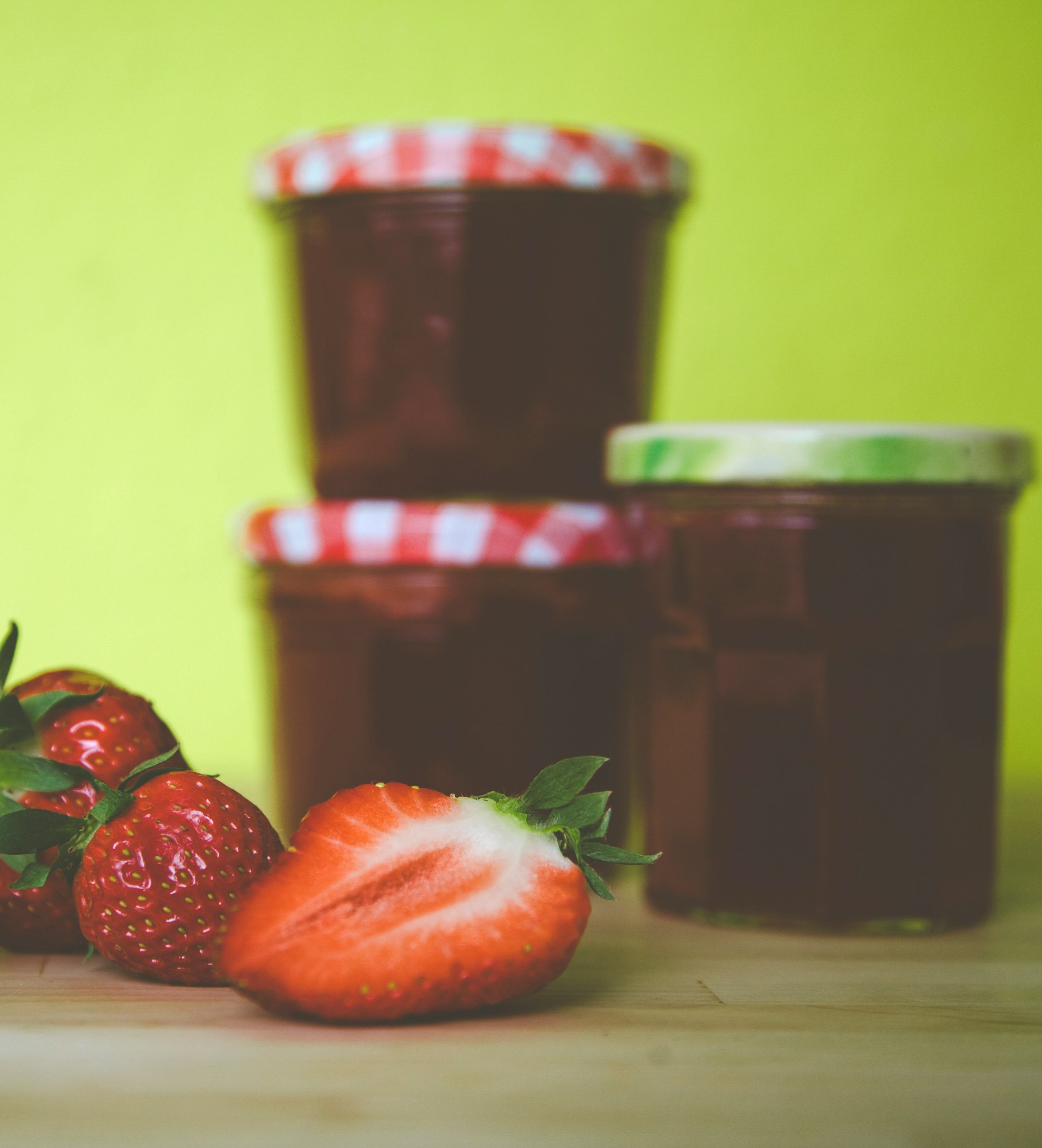 Homemade strawberry jam with fresh strawberries infront