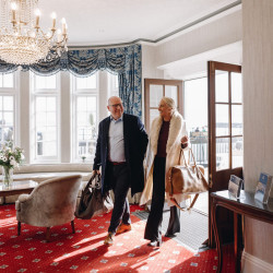 Guests walking through hotel entrance