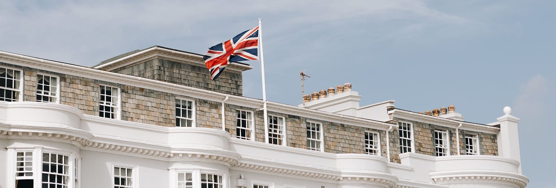 Union flag on roof with blue sky