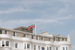 Union flag on roof with blue sky