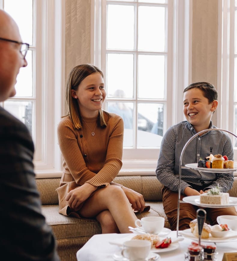 Family enjoying afternoon tea on terrace