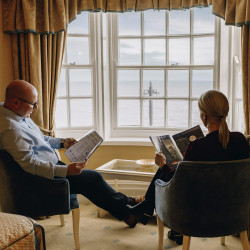 Guests reading by window