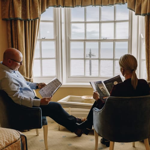 Guests reading by window