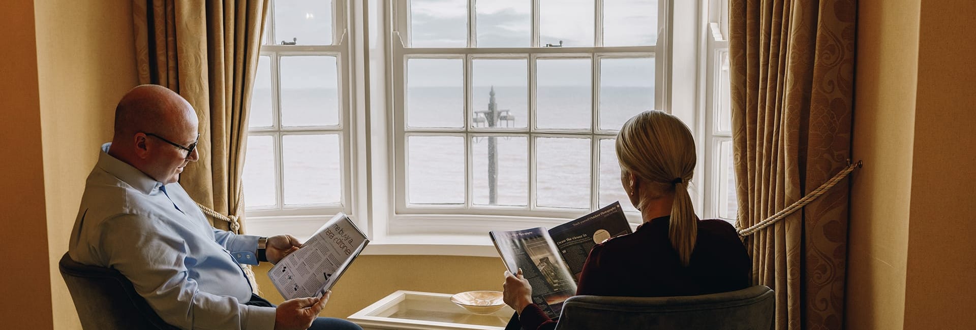 Guests reading by window