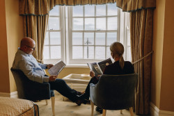 Guests reading by window