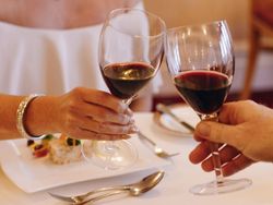 Guests with wine in dining room