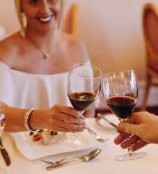 Guests with wine in dining room