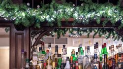 Bar with a variety of liquor bottles and festive garland with lights