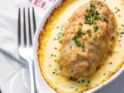 Baked dish served at The Imperial Hotel, topped with melted cheese and chopped chives.