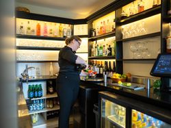 Lady pouring glass of wine in Bar Area