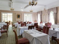 Tables laid out with white cloth and cutlery