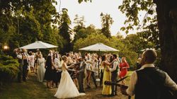Group of people enjoying themselves at wedding outdoors