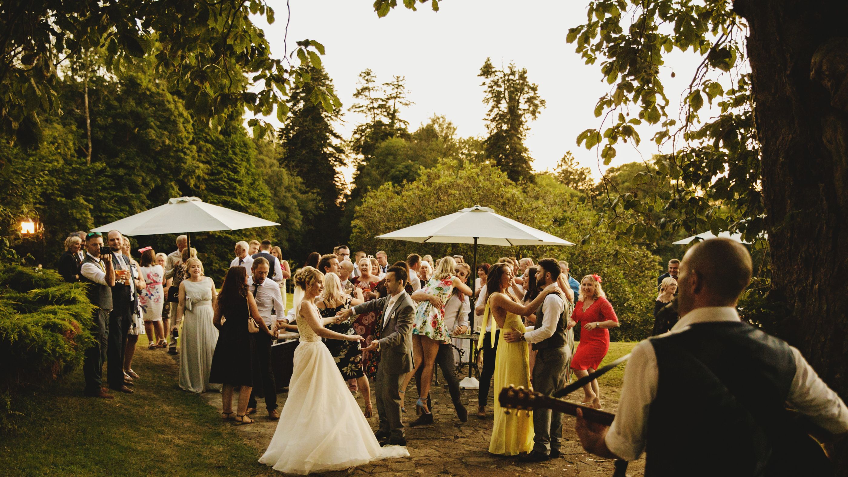 Group of people enjoying themselves at wedding outdoors