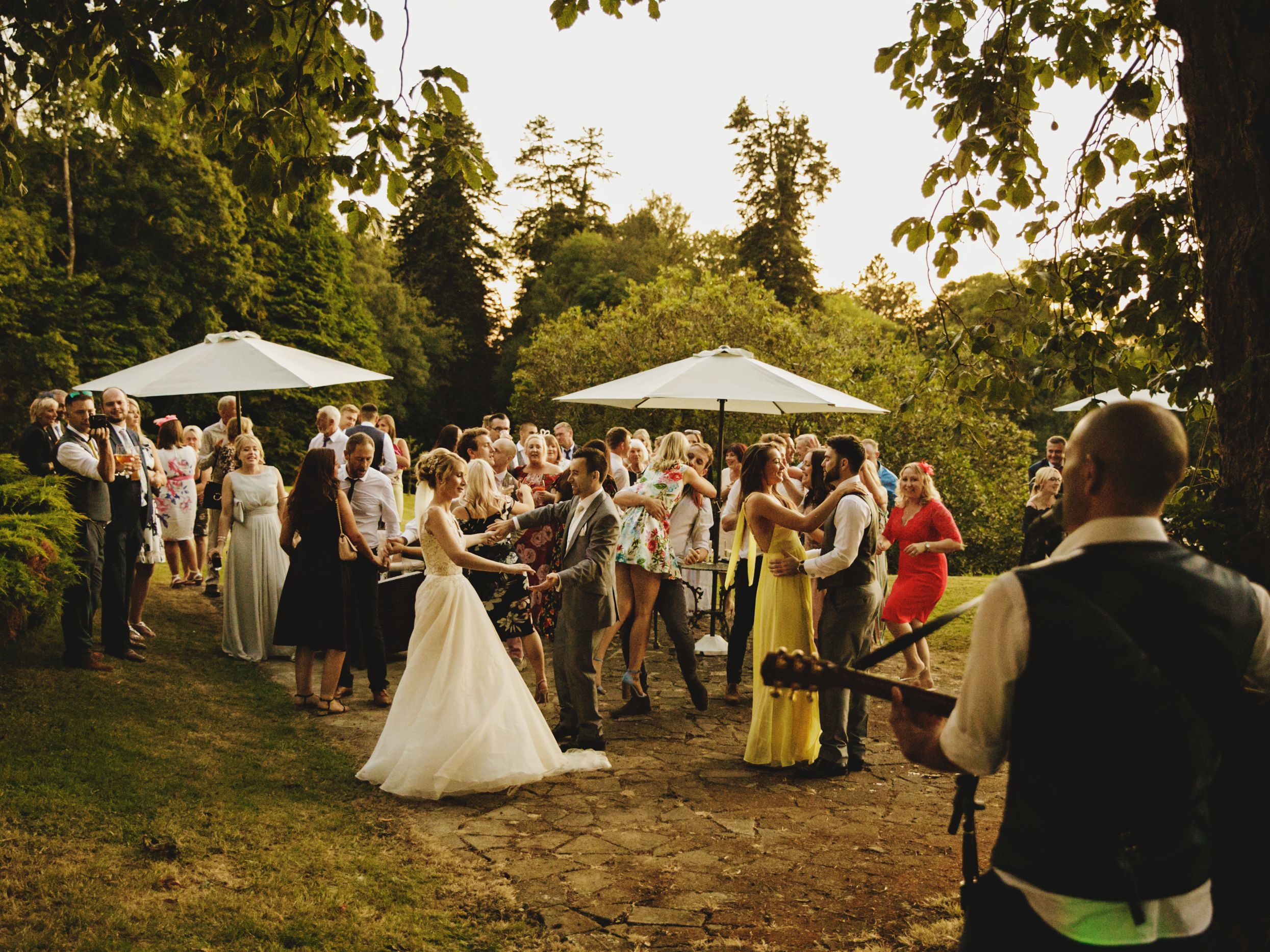Group of people enjoying themselves at wedding outdoors