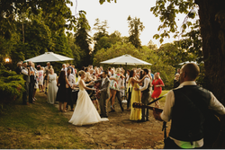 Group of people enjoying themselves at wedding outdoors