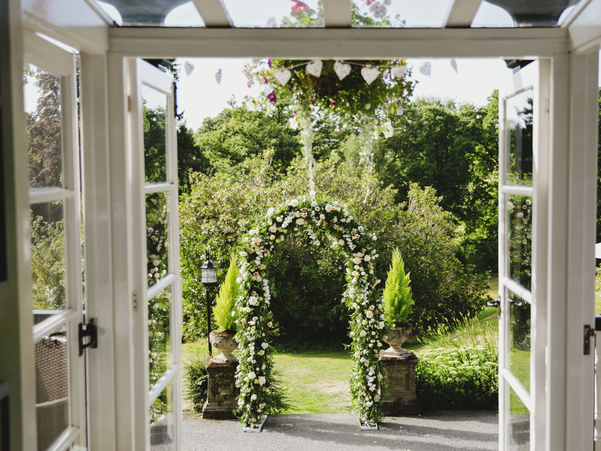 Grass archway seen through open glass doors