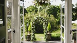 Grass archway seen through open glass doors