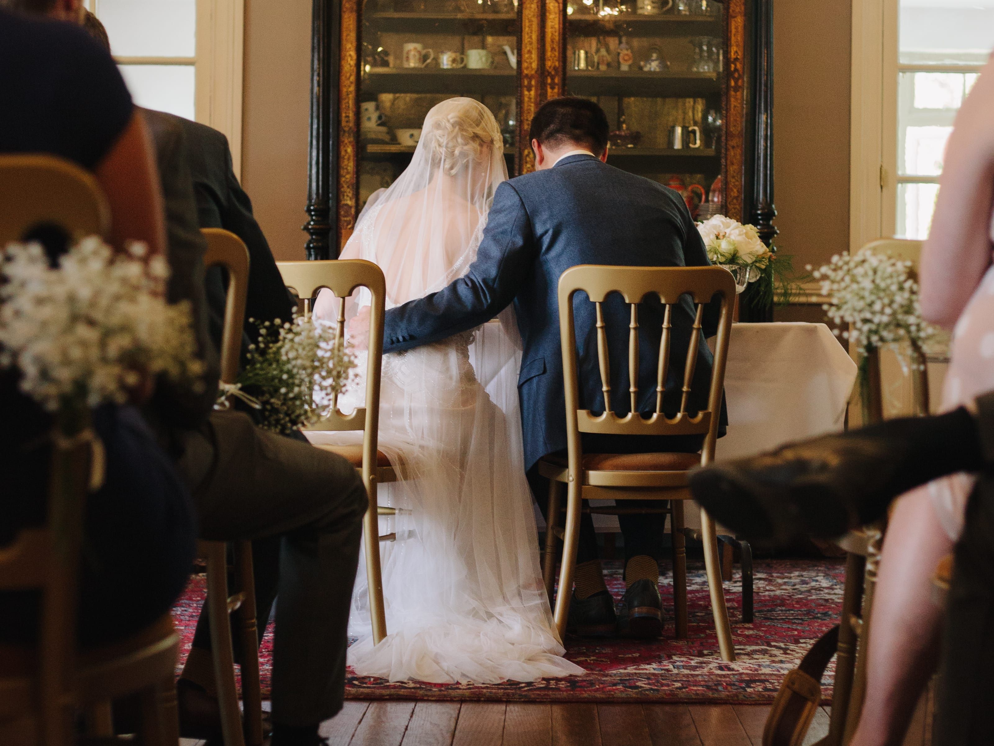 Bride and Groom sat at alter